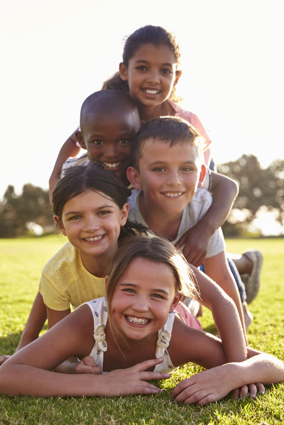 children laying on grass